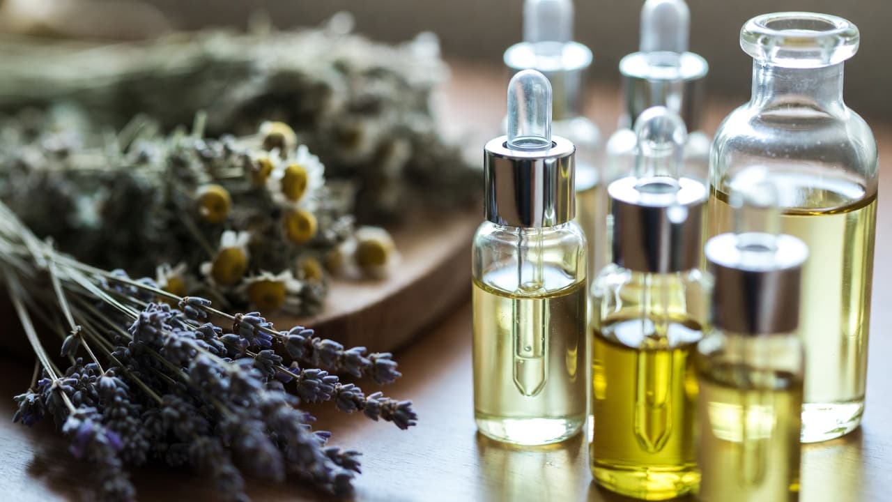 Organic olive oil and coconut oil in glass jars — the carrier oils used in InVine herbal balms